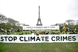 Activistas sostienen una pancarta en París durante la Cumbre Mundial por el Clima.